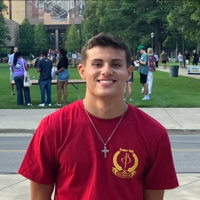 Headshot of Will Marasco. Will is standing on campus in a red shirt.